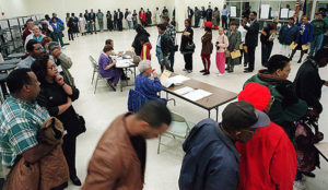 People waiting in line to vote at a polling place